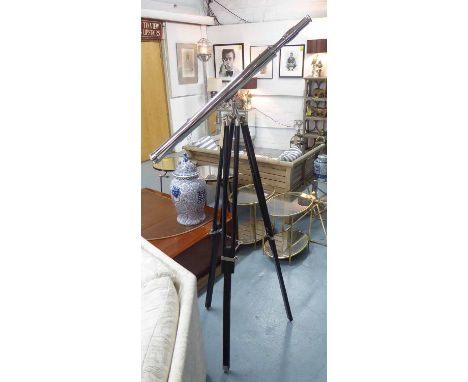 TELESCOPE ON TRIPOD, 1920s English style on ebonised tripod, 150cm H.
