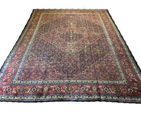 ANTIQUE TABRIZ CARPET, 372cm x 268cm, concentric mahi design fields within corresponding bands and borders. 