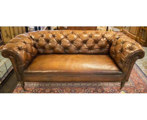 VICTORIAN CHESTERFIELD SOFA, allover deep button upholstered leaf brown leather with curved back and arms and turned front su