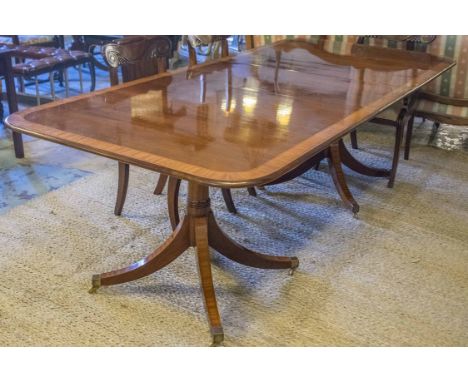 DINING TABLE BY BRIGHTS OF NETTLEBED, Regency design mahogany and satinwood crossbanded with rounded ends twin pillar outswep