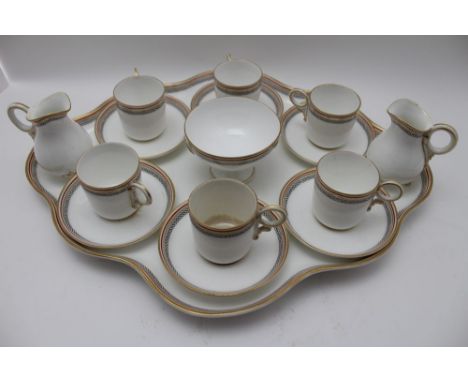 A Worcester ceramic coffee set, comprising; shaped tray with six cans &amp; saucers, sugar bowl, and a pair of cream jugs, wh