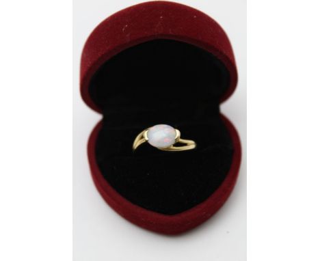 An 18k gold ring set an oval cabochon opal, gross weight: 3.6g, ring size: 'P' (in heart shaped ring box) 