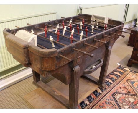 A circa 1930s North European wooden framed table football game of Art Deco design, having steel handles and cast metal 10 a-s