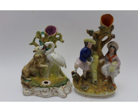 A 19th century Staffordshire pottery inkwell with taper stick holder back, modelled with a dog &amp; swan 19cm high, together