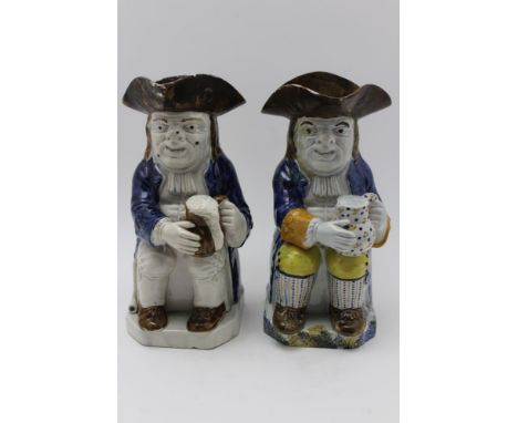 Two 19th century Pratt ware ceramic Toby jugs, modelled as seated figures in 18th century costume nursing foaming jugs of ale