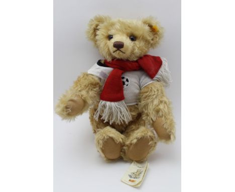 An original Steiff Classic growling mohair Bear, in football shirt and supporters' scarf, no. 004377, 44cm high