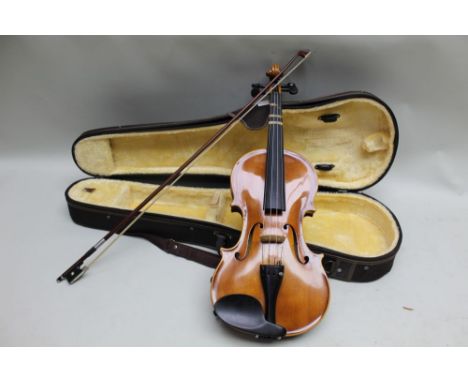 A modern Korean made copy of a Stradivarius violin by Nyojeong having 14 inch two piece back, housed in a plush lined case wi