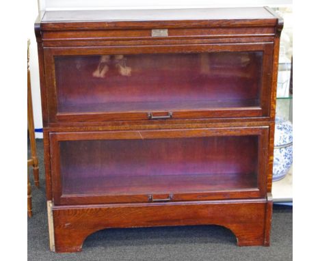 Vintage oak bassisters two level bookcase each shelf with opening glass, maker's badge to front "Butterworths Building Up Boo