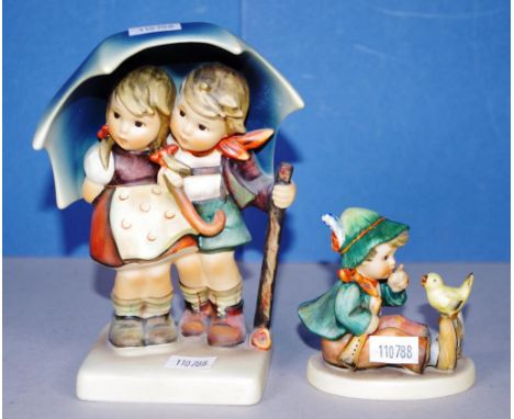 Two West German Hummel figurines to include a girl & boy under a umbrella and a seated boy with bird, height 15.5cm approx (t