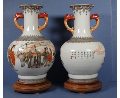 Pair Chinese hand painted ceramic vases each with hand painted figural decoration, dual handled, character marks to bases, on
