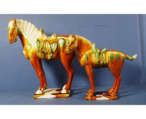 Pair graduated Chinese ceramic Tang style horses. Height 21cm and 28cm approx.