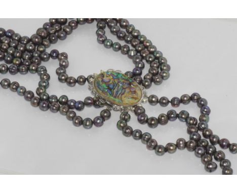 Boxed three strand pearl necklace with paua shell clasp (worn to the front), freshwater pearls in silvery colour