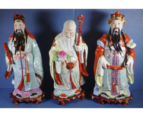 Set three Chinese large ceramic sage figures three immortals, decorated in polychrome colours. Each on a carved wood stand. H