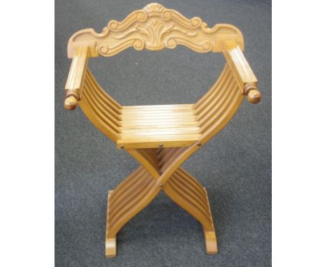 Vintage carved timber X form chair decorated with carved scroll back, width 65cm approx