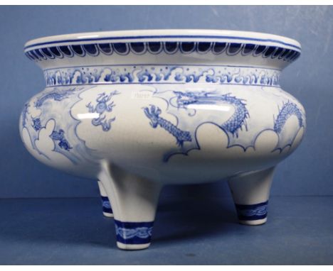 Large Chinese blue & white ceramic bowl dragon decorated, tri-footed. Diameter 31cm approx Height 20cm approx.