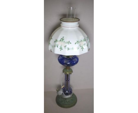Antique English kerosene banquet lamp with blue flashed glass reservoir and hand painted white glass shade, converted to elec