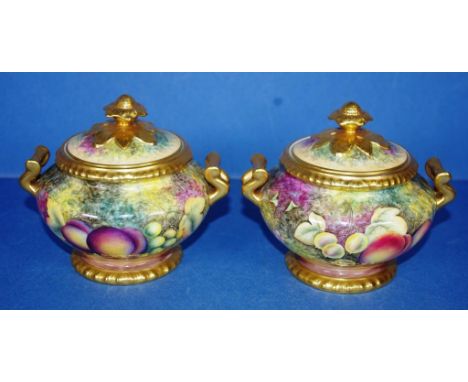 Pair of Royal Worcester lidded pots gilt & decorated with handpainted fruit studies, 12cm high approx.