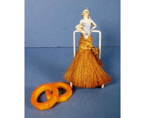 Vintage ceramic half doll crumb brush height 15cms approx (total); together with 2 early composition orange napkin rings.