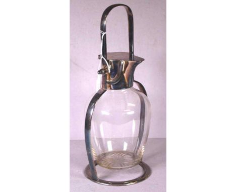 Christopher Dresser style silver plated decanter crystal glass decanter in silver plated frame with tipping action. No marks 