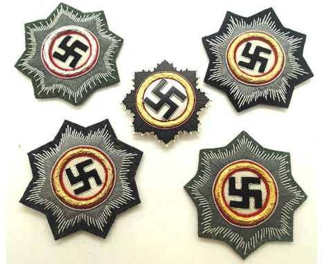Four embroidered fabric Deutches Kreuz awards and an enamelled metal example with a pin verso. P&amp;P Group 1 (£14+VAT for t