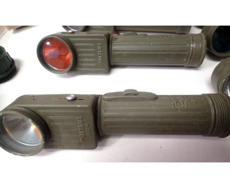 Twelve military issue torches, mostly German. P&amp;P Group 3 (£25+VAT for the first lot and £5+VAT for subsequent lots) 