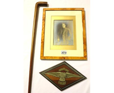 Lt. Griffiths, 191 Squadron RAF, a painted mess plaque, a later framed portrait and walking cane inlaid with a mother of pear