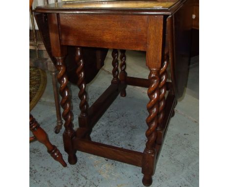 Oak drop leaf gate leg table on barley twist supports 