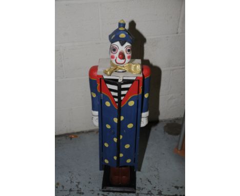 Painted wood shelf unit in the form of a clown with twin doors 