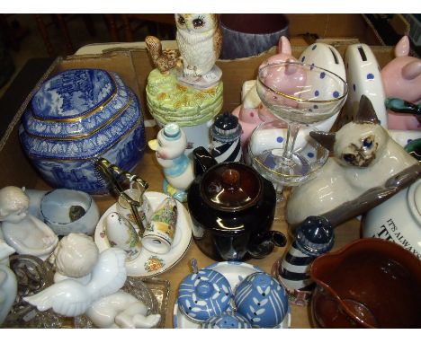 Box of miscellaneous decorative ceramics including Ringtons tea caddy, a musical Beatrix Potter pig book ends, lighthouse sal