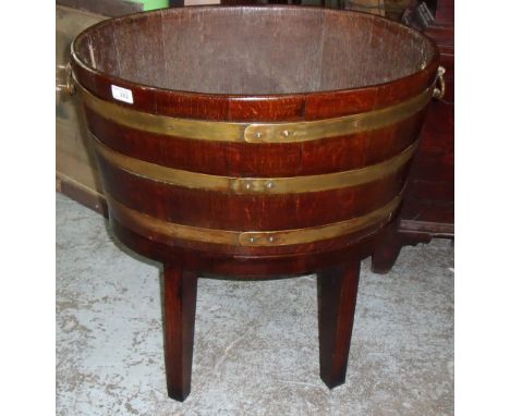 Oak and brass coopered barrel planter on wooden stand 