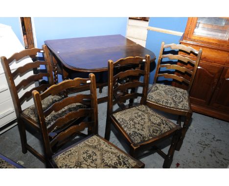 Oak drop leaf dining table on barley twist legs and a set of five oak ladder back chairs 