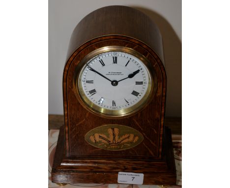 Oak cased mantel clock with white enamel dial W. Greenwood Leeds & Huddersfield with inlaid detailing on brass bun feet 