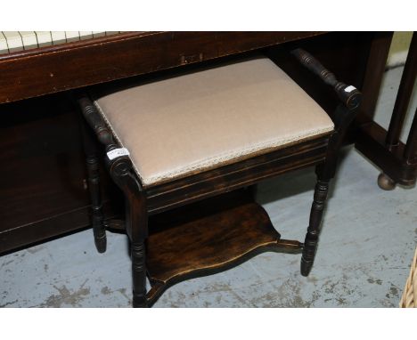 Late Victorian piano stool with lift up seat and under tier shelf 