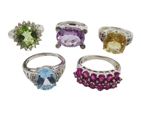 Five silver stone set rings including amethyst and white topaz, Swiss blue and white topaz, ruby, green quartz and white topa