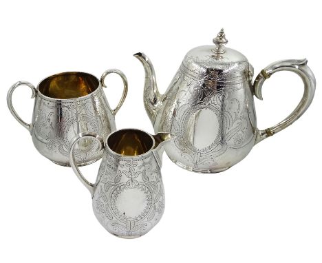 Victorian silver three piece baluster tea service, with bright cut decoration and cartouche by Martin, Hall &amp; Co, London 