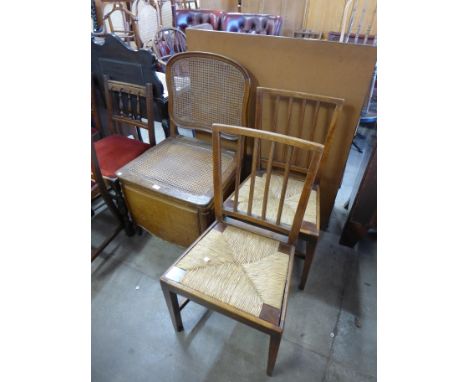 An oak bergere commode chair and a pair of George III elm rush seated chairs 