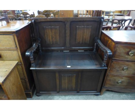 A carved oak linenfold monks bench 