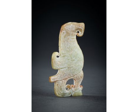 AN ARCHAISTIC CELADON JADE 'BIRD' PENDANTChina, 20th century. Carved in the style of the Western Zhou Dynasty, demonstrating 