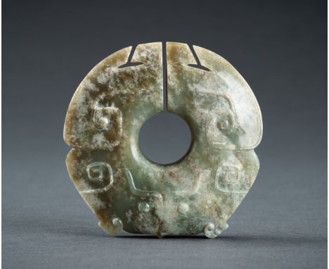AN ARCHAISTIC CELADON JADE 'ZOOMORPHIC' PENDANTChina, 20th century. Beautifully executed in manual carving to display a high 