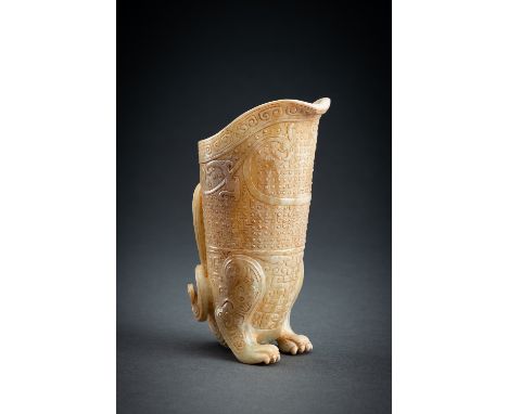 AN ARCHAISTIC CELADON JADE 'CHILONG' RHYTONChina, 20th century. A well-crafted rhyton in the Han Dynasty style, showcasing su