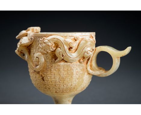 AN ARCHAISTIC CELADON JADE 'CHILONG' WINE CUPChina, 20th century. A fine carving that captures the intricate beauty of the Ha