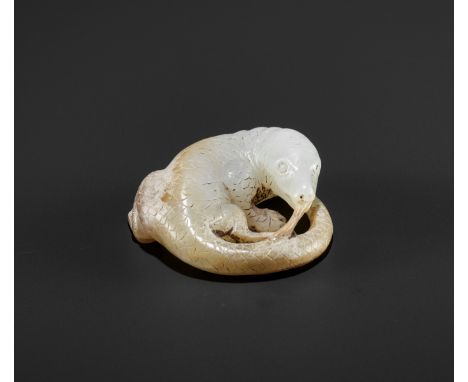 AN ARCHAISTIC WHITE AND RUSSET JADE FIGURE OF A LIZARD, QINGChina, Qing dynasty (1644-1912). Skillfully carved without the us