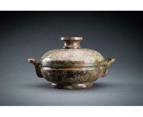 A LARGE AND RARE CELADON JADE FOOD VESSEL, GUI, QING DYNASTYChina, Qing Dynasty (1644-1912). Masterfully crafted to resemble 