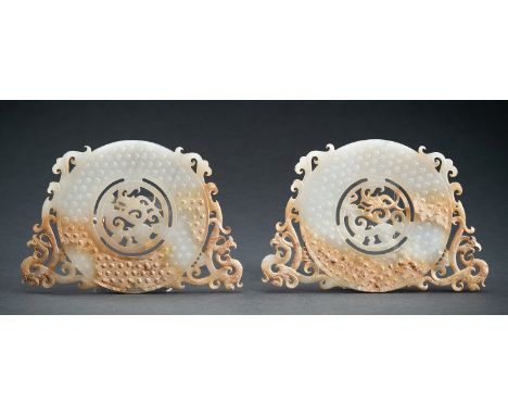 A PAIR OF ARCHAISTIC WHITE AND RUSSET JADE 'PHOENIXES AND DRAGON' BI DISCSChina, 20th century. Manually crafted in the style 
