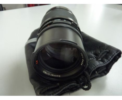 A HASSELBLAD 180MM F4 CF CARL ZEISS SONNAR T* LENS, fitted with two lens caps and padded bag