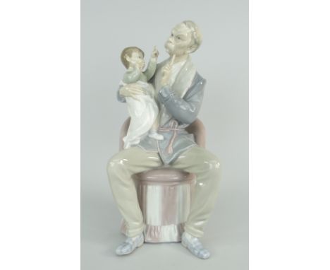 LLADRO PORCELAIN MODEL OF A MOUSTACHED GRANDFATHER &amp; INFANT ON HIS LAP seated on a pink chair