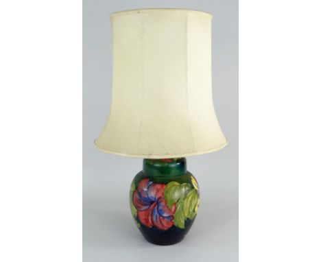 WILLIAM MOORCROFT POTTERY 'HIBISCUS' PATTERN TABLE LAMP with green / blue ground (ginger jar converted), bears Queen Mary lab