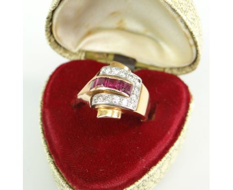 YELLOW METAL DIAMOND &amp; RUBY LADIES RING, the four central rubies surrounded by horseshoe of diamonds, 6gms, in box