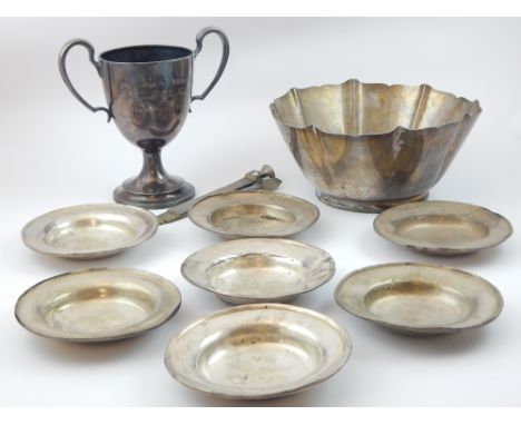 Sterling silver 'petal' form flared bowl on circular foot, seven small circular white metal dished plates, a silver and brass