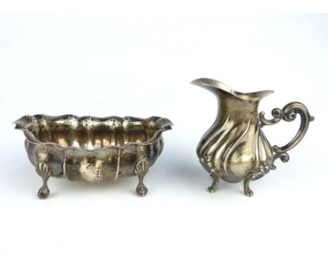 Italian silver cream jug, with spiral embossed body, together with a similar oval silver sugar bowl. (2)